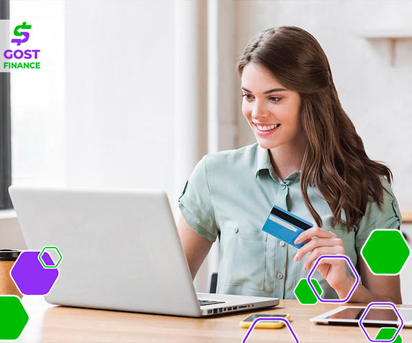 Interest rates on secured and unsecured loans Girl working on a laptop and holding a credit card